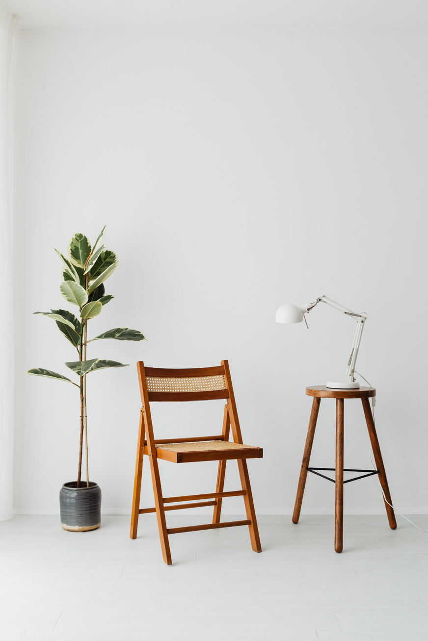Brown Wooden Chair Between Potted Green Plant and Stool
